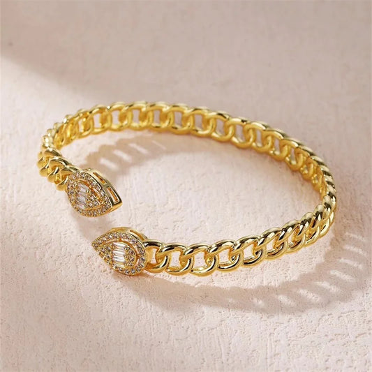 a gold chain cuff bracelet with a diamond clasp