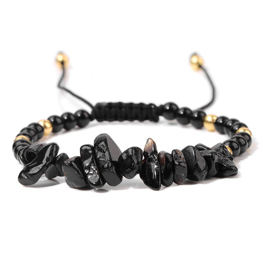 a black beaded bracelet with gold accents