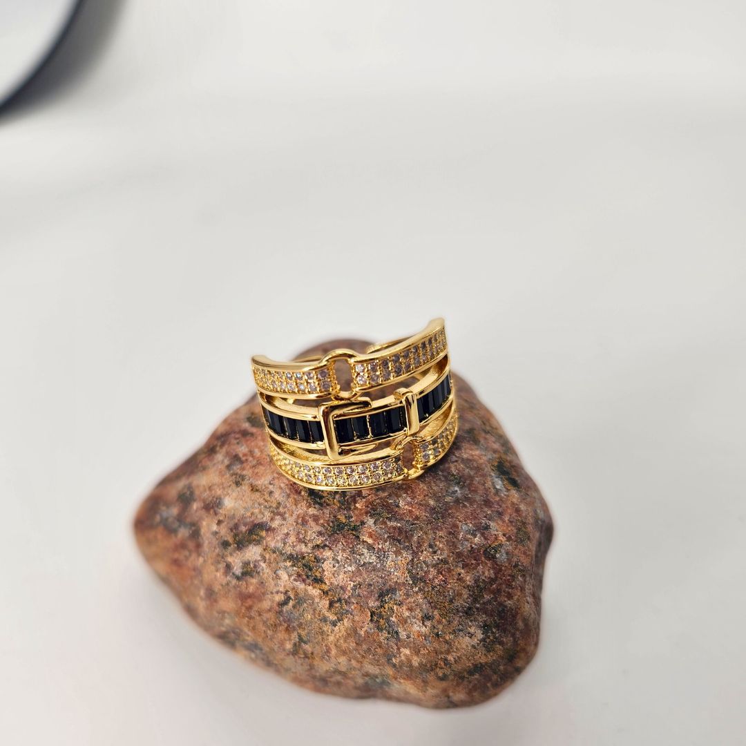 a gold ring sitting on top of a rock