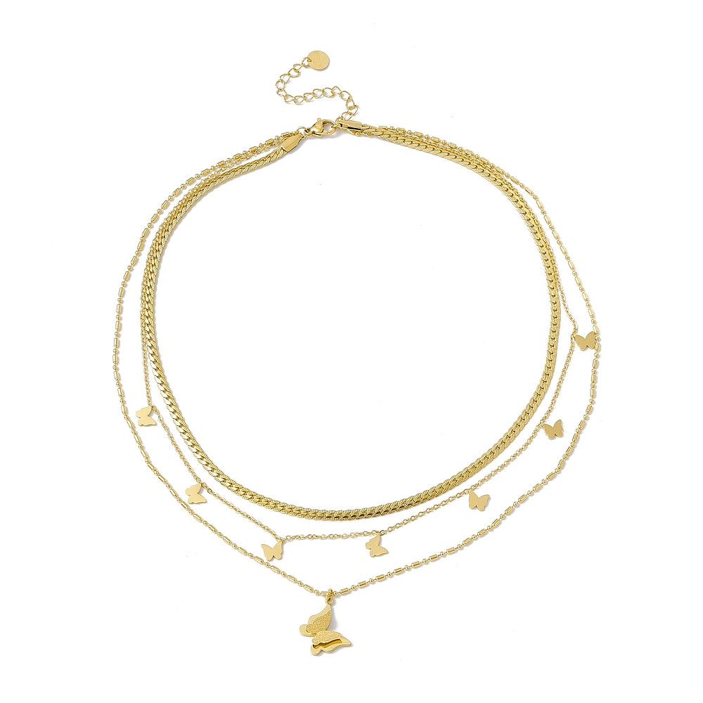 a three layer necklace with gold charms