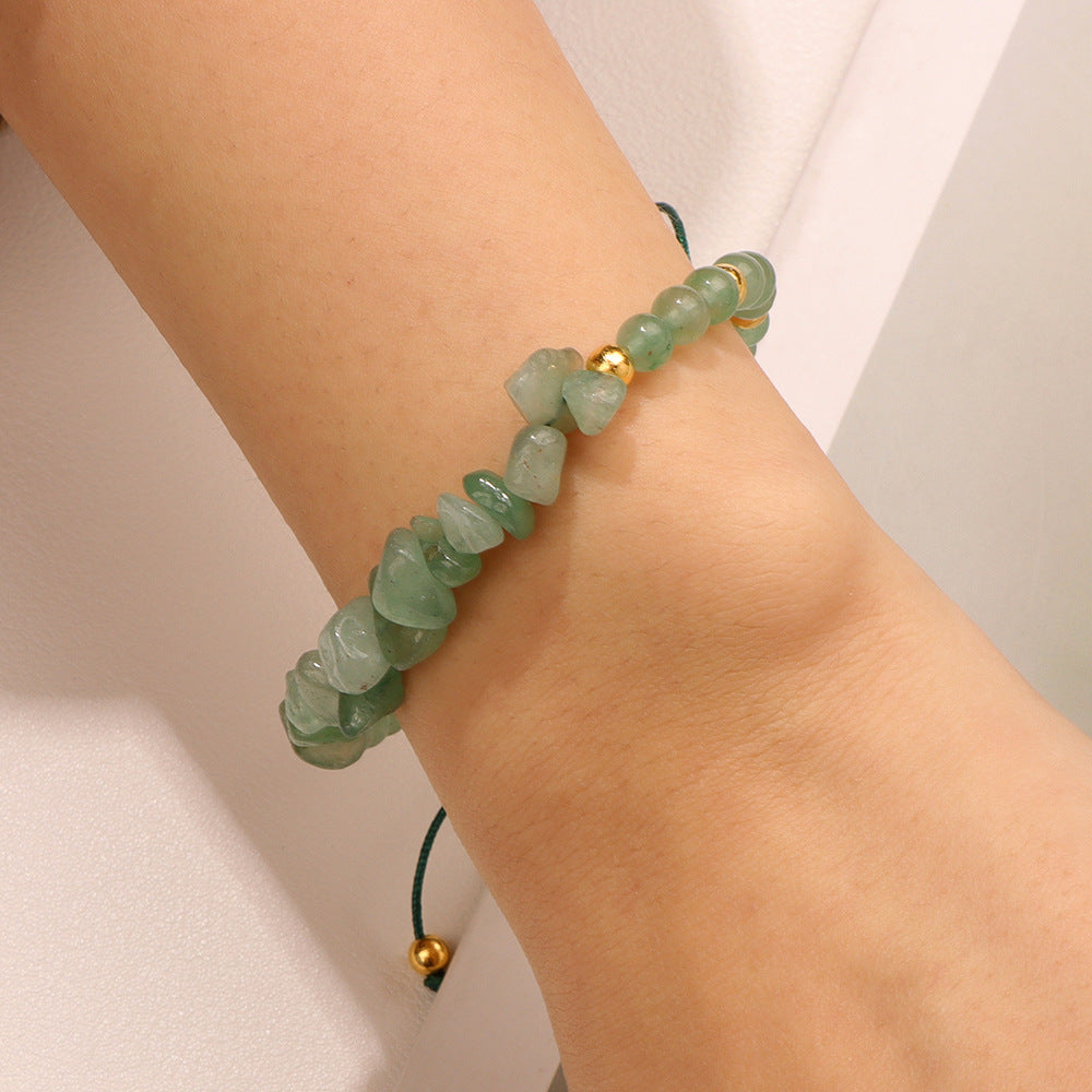 a woman's arm with a green bracelet on it