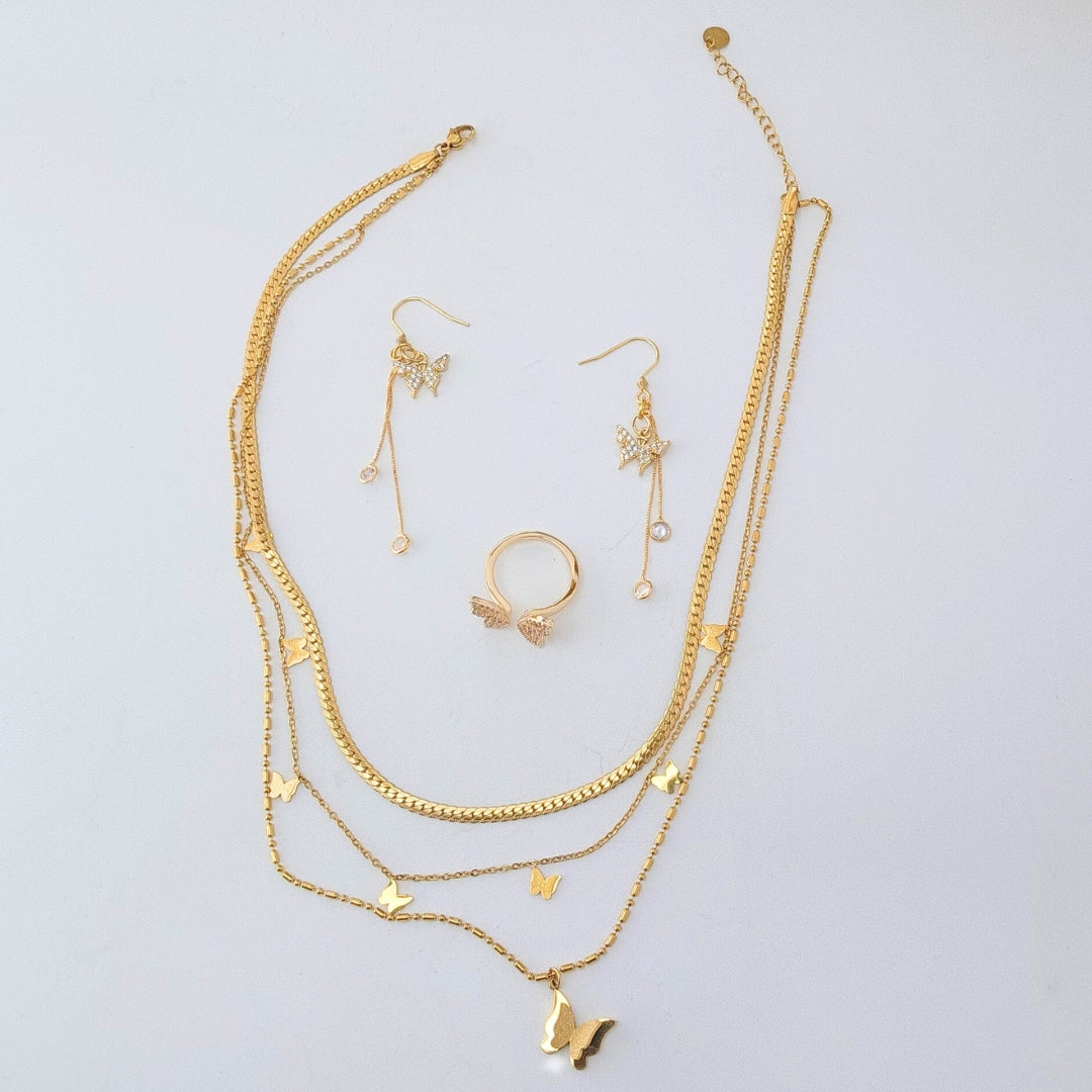 a set of gold jewelry on a white background
