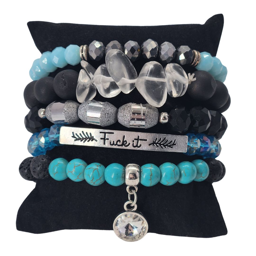 a stack of bracelets with beads and charms